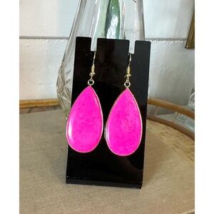Hot pink, gold-tone dangle earrings in a teardrop shape